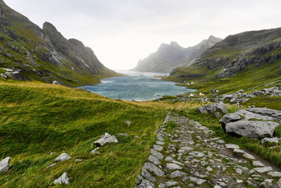 Scenic view of hiking trail leading to remote village vinstad at the coast in lofoten norway