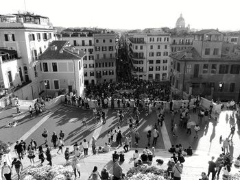 High angle view of crowd on city street by buildings