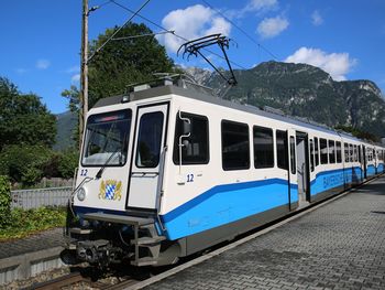 Train by railroad tracks against sky