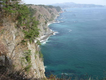 High angle view of sea by mountains