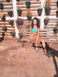 Full length of woman sitting on staircase