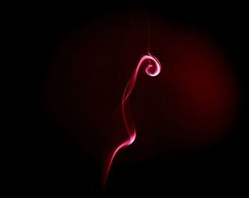 Close-up of red light over black background