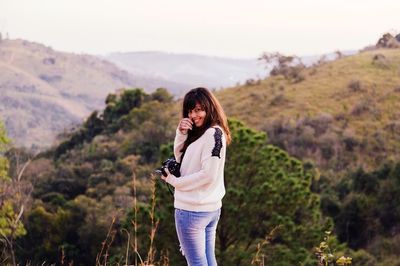 Woman standing on grassy landscape