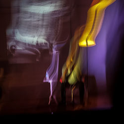 Blurred motion of women standing on illuminated stage