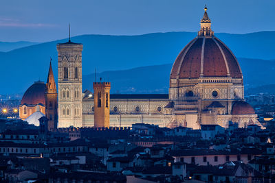 View of buildings in city at dusk