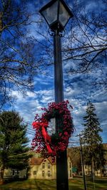 Low angle view of street light against cloudy sky