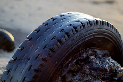 Close-up of tire at beach