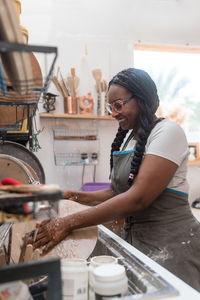 Woman washing her pottery at the ceramics studio