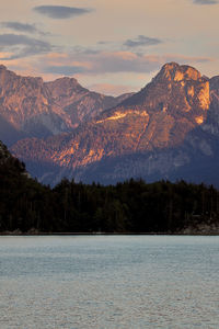 Scenic view of snowcapped mountains against sky during sunset