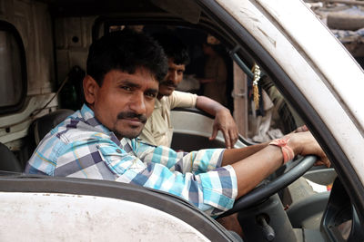 Portrait of man sitting in car