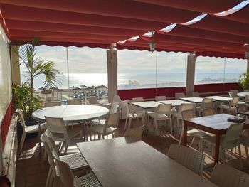 Empty chairs and tables at restaurant