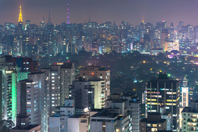 Aerial view of illuminated buildings in city at night