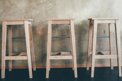 Wooden stools against counter at bar