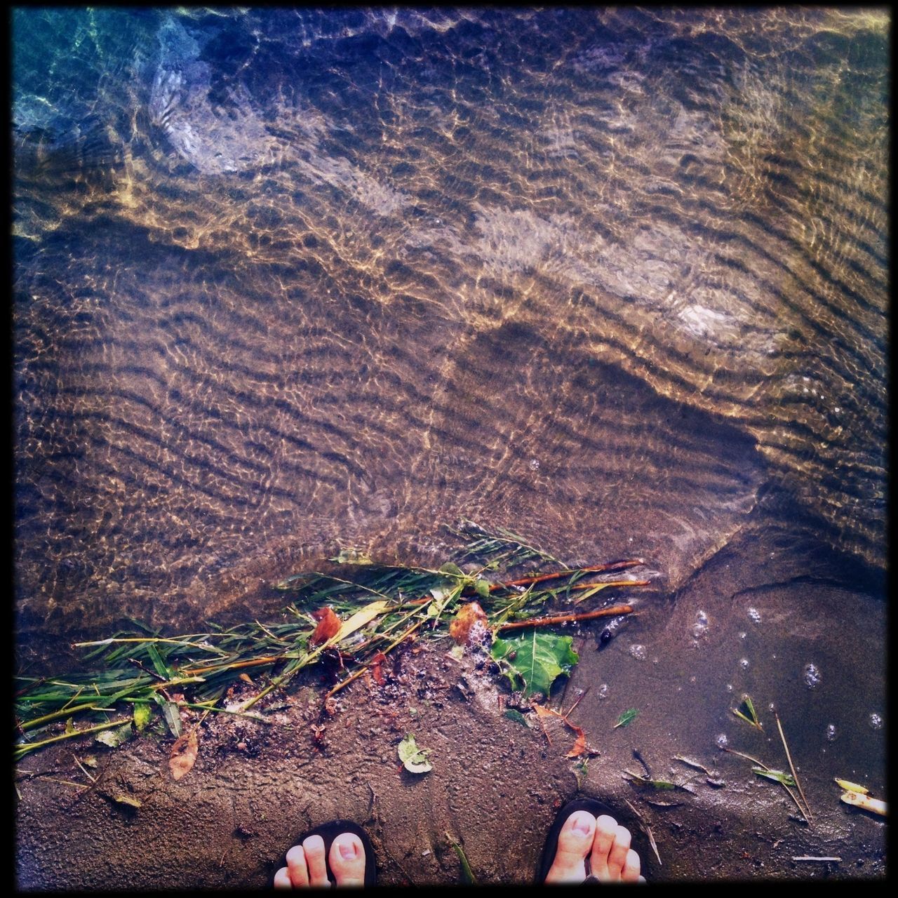 transfer print, auto post production filter, water, high angle view, nature, low section, person, rock - object, textured, outdoors, day, tranquility, part of, close-up, unrecognizable person, personal perspective, wood - material