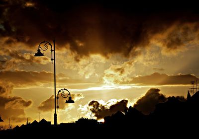 Low angle view of street light against sky during sunset
