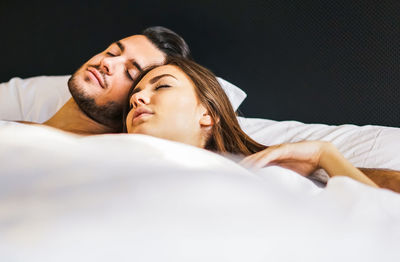 Young couple sleeping on bed