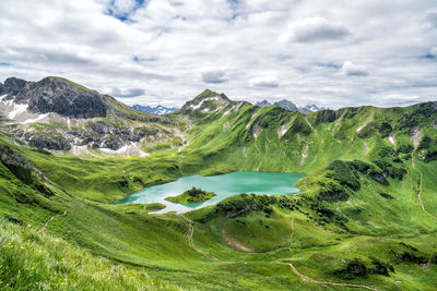 Scenic view of lake and mountains against sky