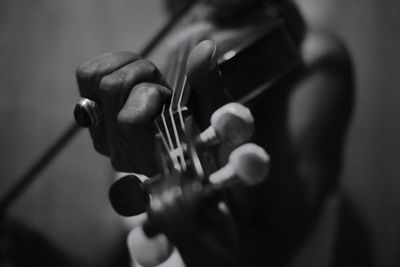 Close-up of hand playing violin