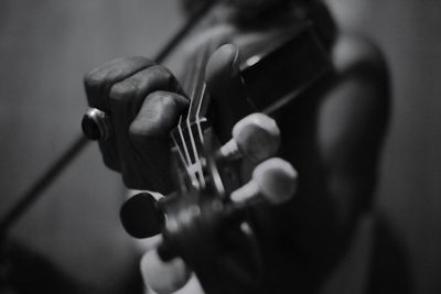 Close-up of hand playing guitar