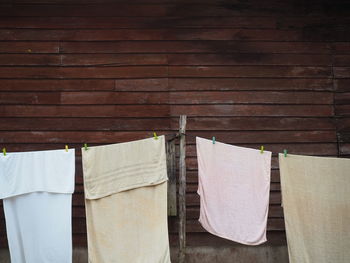 Towels hanging on clothesline against wall