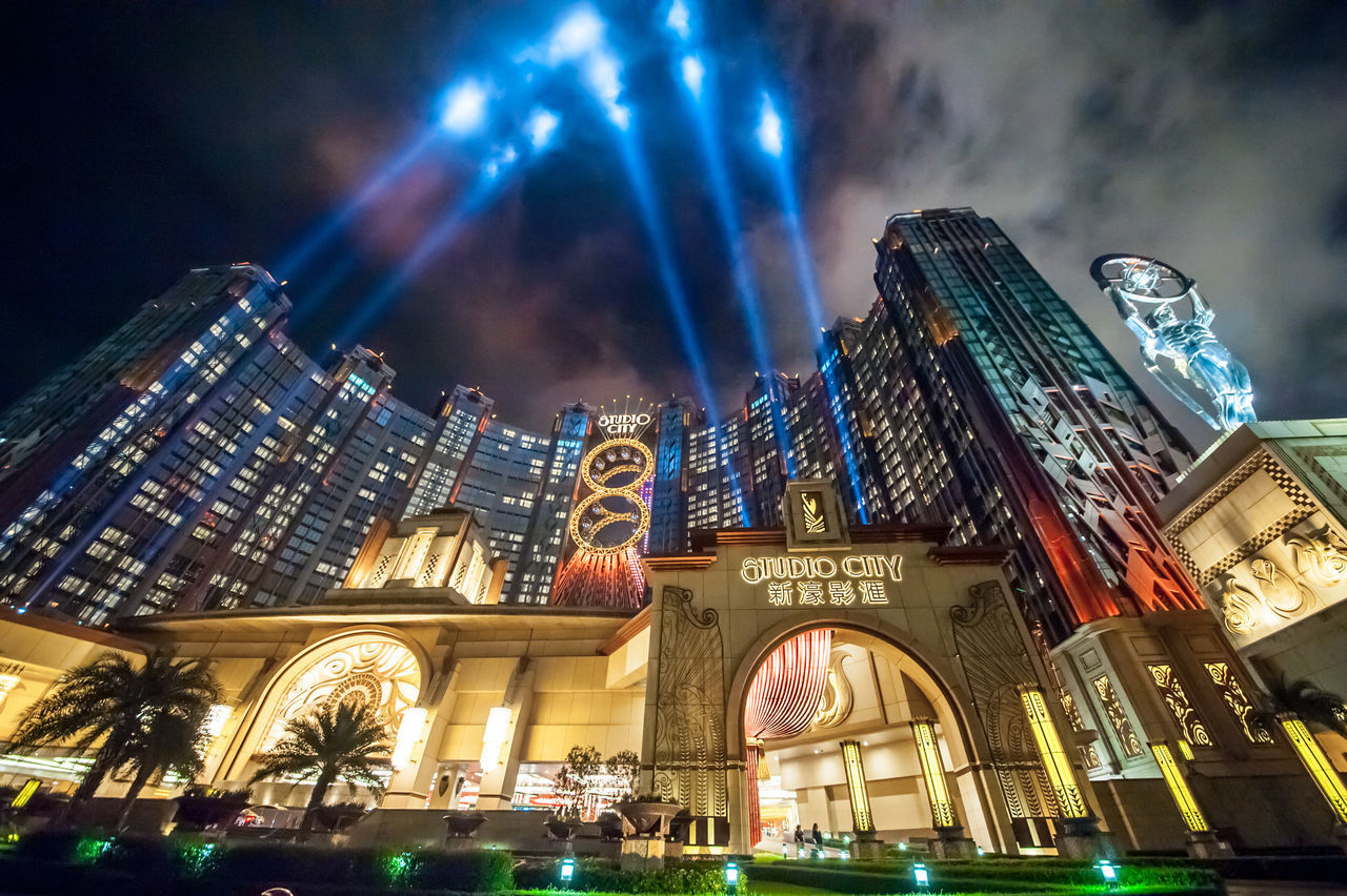 LOW ANGLE VIEW OF ILLUMINATED BUILDINGS AT NIGHT