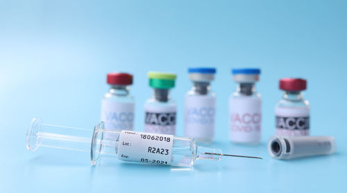 Close-up of wine bottles against blue background