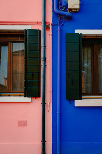 Detail on houses colored pink and blue in burano