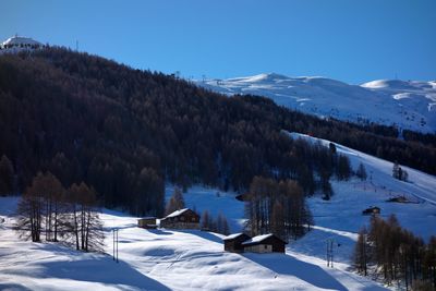 Scenic view of snow covered mountains against sky