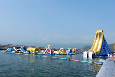 Sailboats in sea against clear blue sky