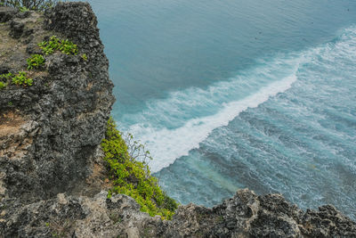 High angle view of rocks by sea