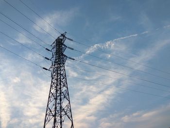 Low angle view of electricity pylon against sky