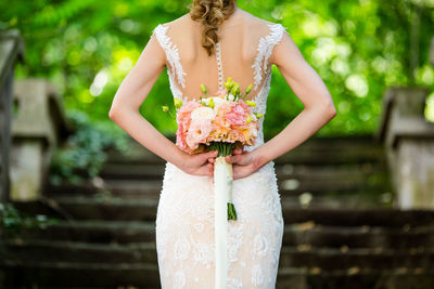 Rear view of bride holding bouquet