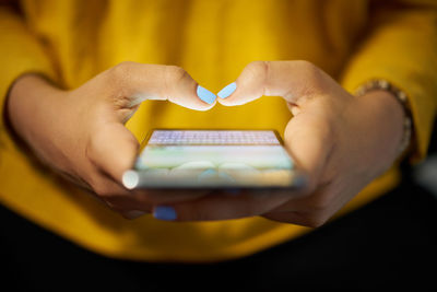 Close-up of hand holding mobile phone