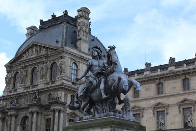 Low angle view of statue against cloudy sky