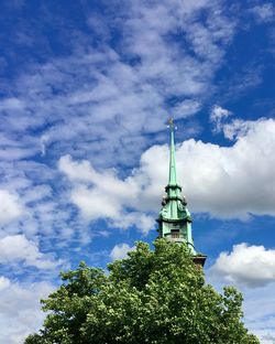 Low angle view of building against cloudy sky