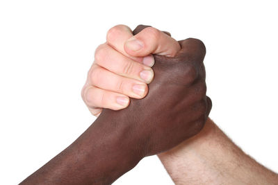 Close-up of arm wrestling over white background