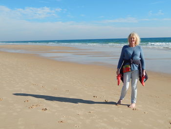 Portrait of senior woman standing on beach