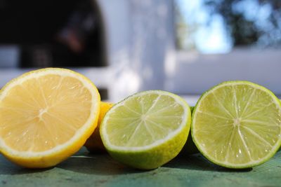 Close-up of lemon and lime slices on table
