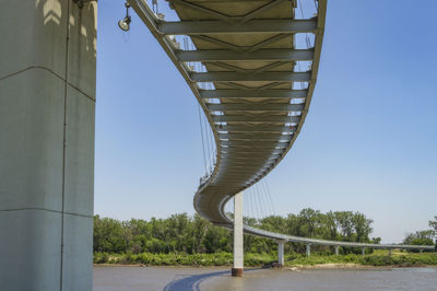 Low angle view of bridge against clear blue sky