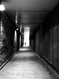 Man walking in illuminated tunnel