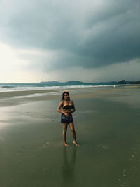 Portrait of woman standing at beach