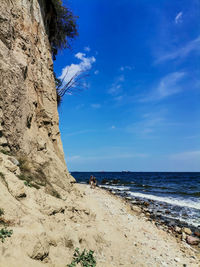 Scenic view of beach against blue sky