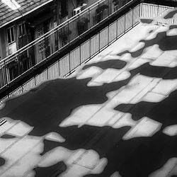 High angle view of shadow on footpath in city