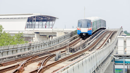 Train on railroad tracks in city against sky