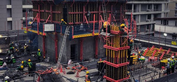 Low angle view of construction site against buildings in city