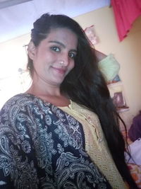 Portrait of smiling young woman at home