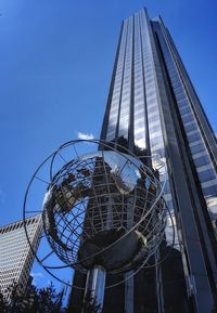 Low angle view of modern building against blue sky