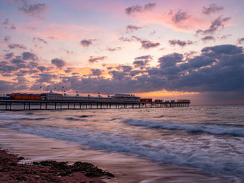 Scenic view of beach against sky during sunset