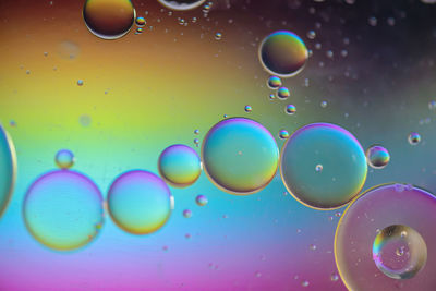Close-up of bubbles against water