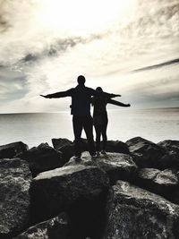 Silhouette couple overlooking calm sea